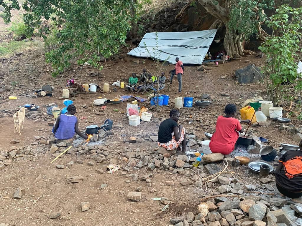 Displaced mothers preparing meals for their families