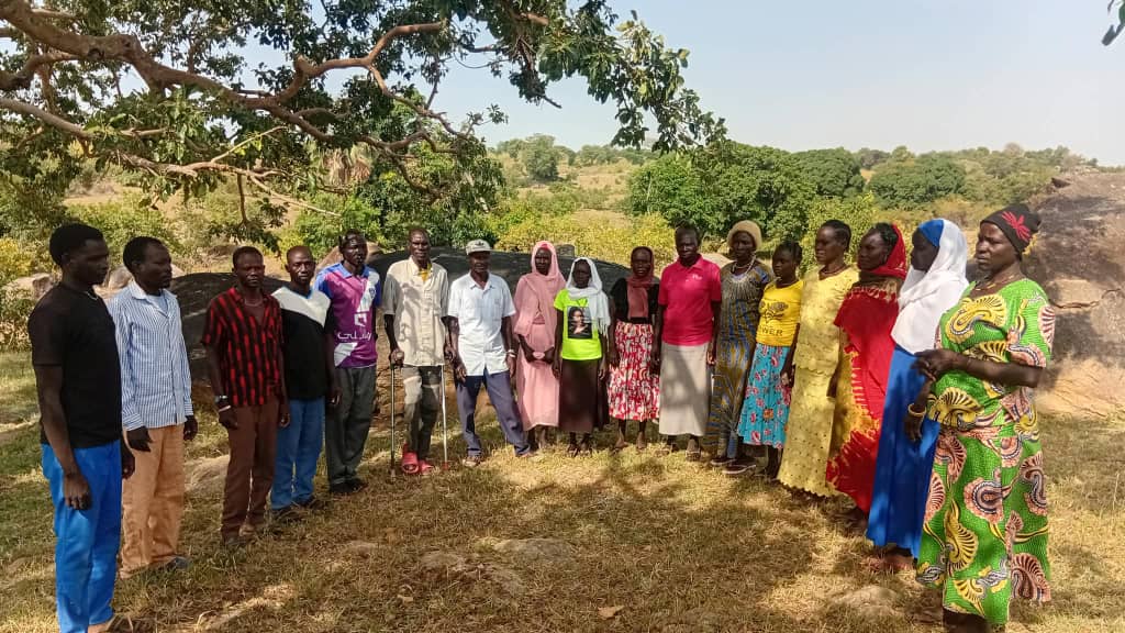 SMIP members and community gathered under a tree